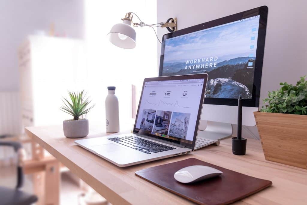 Wooden desk with laptop and second screen